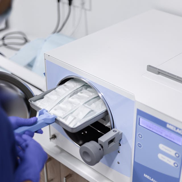 Team examining beaker for accurate diagnosis